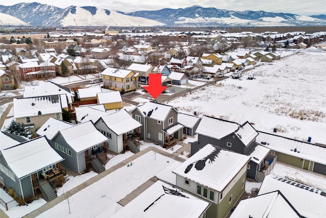 snowy aerial view featuring a mountain view