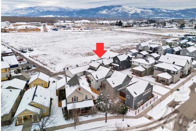 snowy aerial view with a mountain view