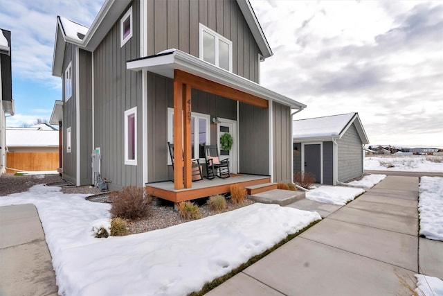 exterior space with covered porch and a storage unit