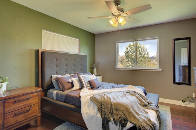 bedroom with baseboards, wood finished floors, and a ceiling fan