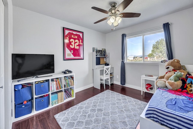 bedroom featuring baseboards, wood finished floors, and a ceiling fan