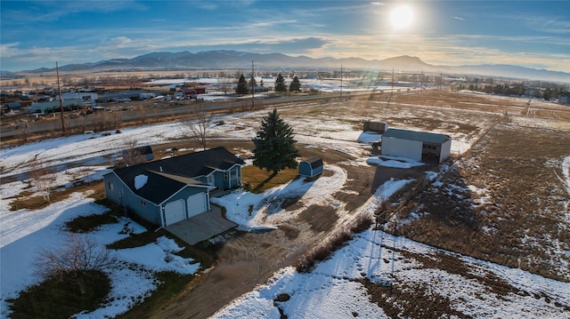 snowy aerial view with a mountain view