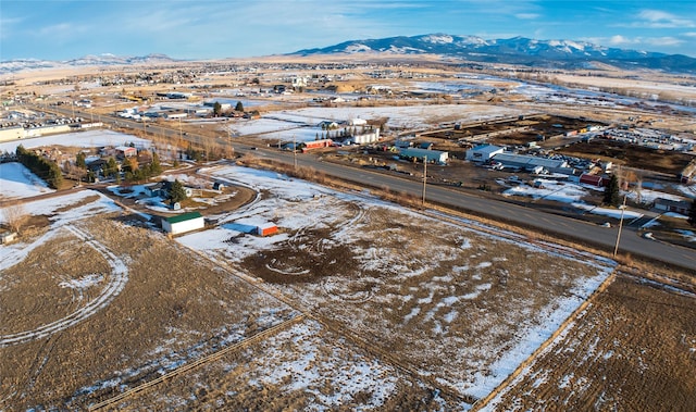 snowy aerial view with a mountain view