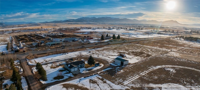 snowy aerial view with a mountain view