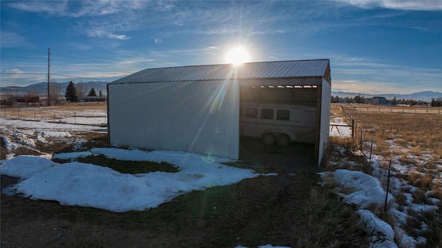 view of pole building featuring a rural view and a mountain view