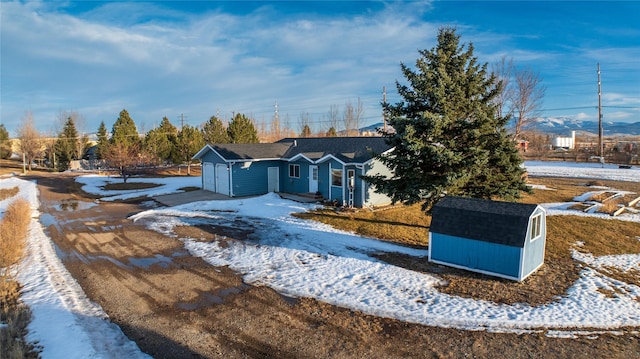 ranch-style house with an outbuilding, an attached garage, and concrete driveway