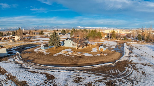 snowy aerial view featuring a mountain view