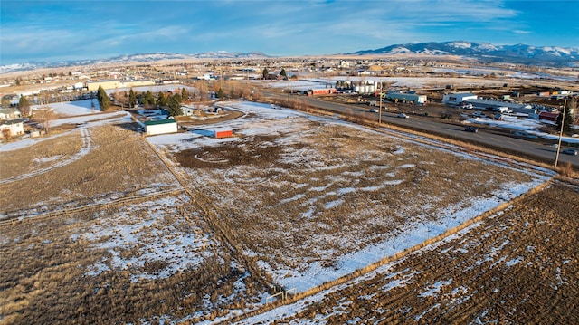 snowy aerial view with a mountain view