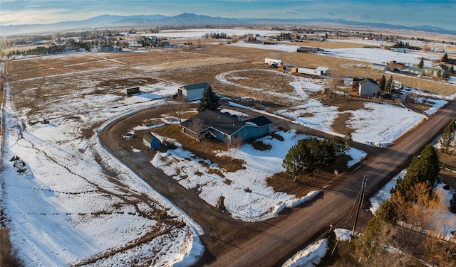 snowy aerial view featuring a mountain view