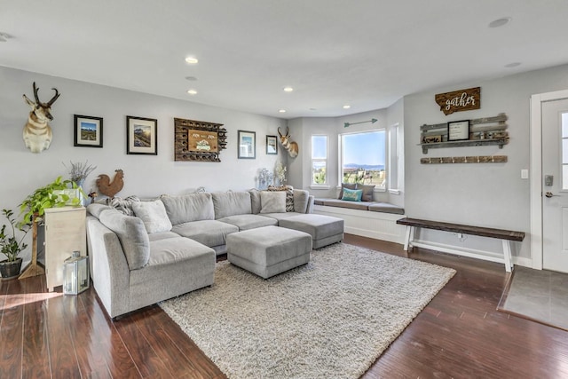 living area featuring recessed lighting, baseboards, and dark wood finished floors