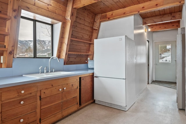 kitchen featuring sink, white refrigerator, wood ceiling, and a mountain view