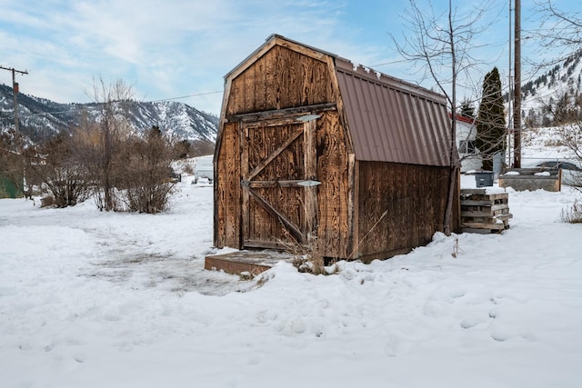 snow covered structure with a mountain view