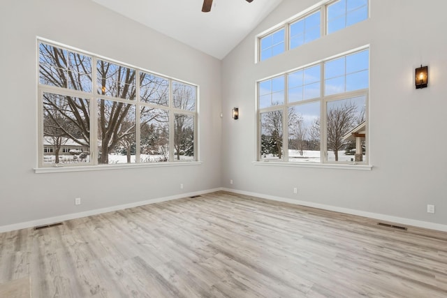 spare room featuring ceiling fan, vaulted ceiling, and light wood-type flooring