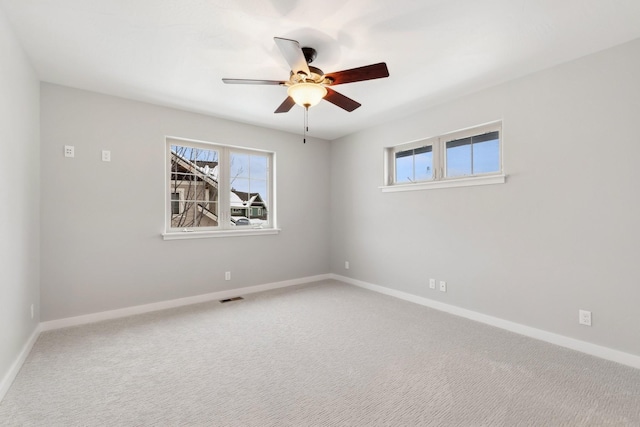 spare room with ceiling fan and carpet floors