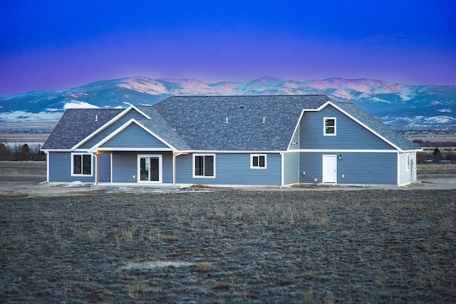 back house at dusk with a mountain view