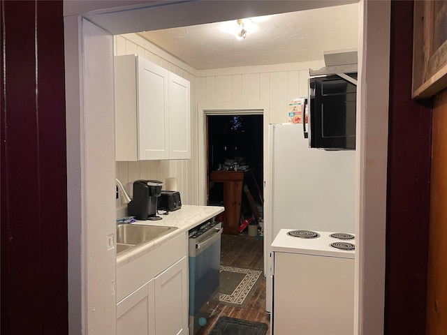 kitchen featuring electric stove, dark wood-type flooring, white cabinets, stainless steel dishwasher, and sink