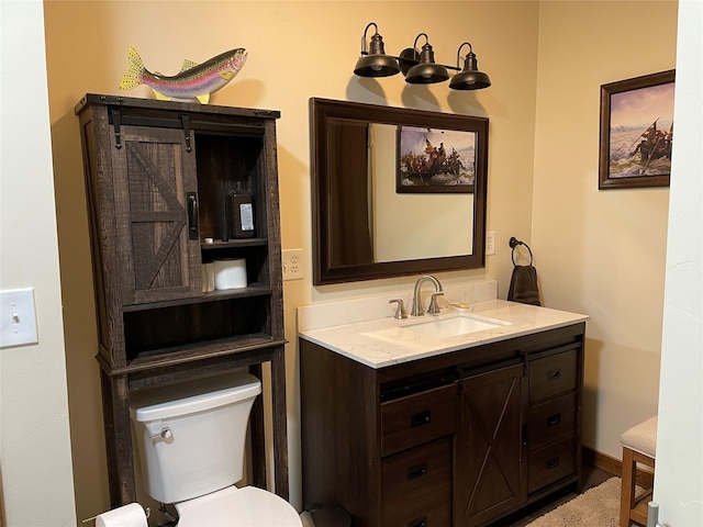 bathroom featuring toilet and vanity