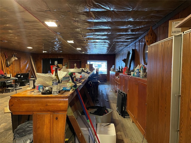 miscellaneous room featuring hardwood / wood-style floors and wooden walls