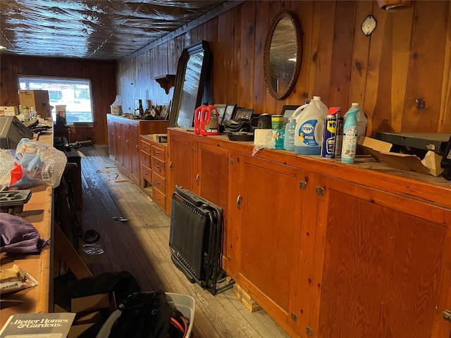 interior space featuring wood walls and light wood-type flooring