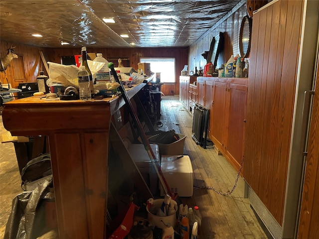 interior space with wood walls and light hardwood / wood-style floors