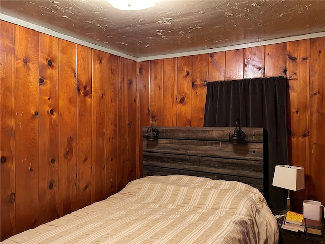 bedroom with wooden walls