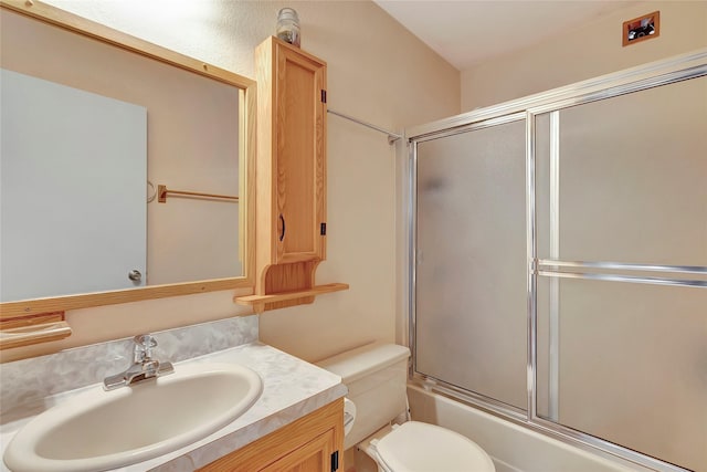 full bathroom with toilet, combined bath / shower with glass door, and vanity