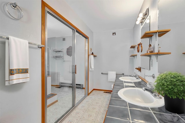 bathroom featuring vanity, a baseboard radiator, and a shower with shower door