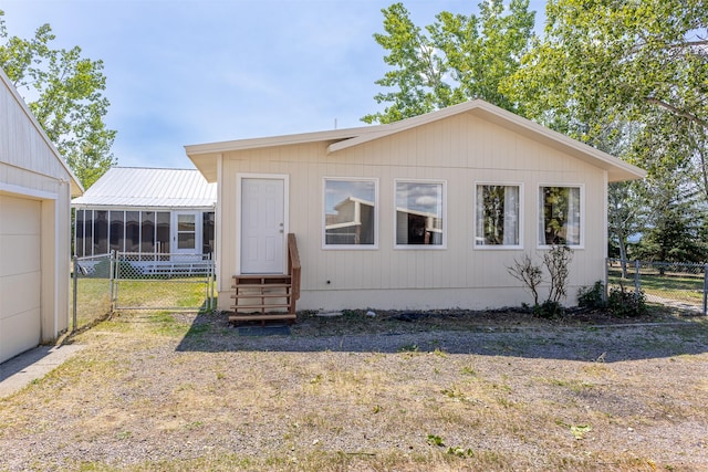 view of front of home featuring a sunroom