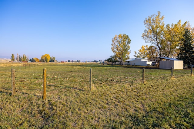 view of yard with a rural view