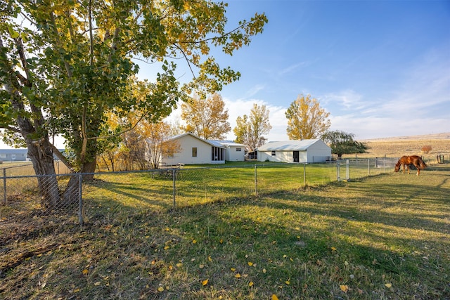 view of yard with a rural view