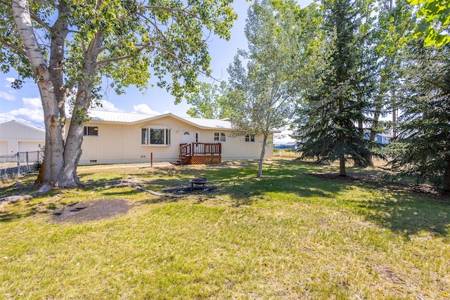 view of yard featuring a fire pit and a wooden deck