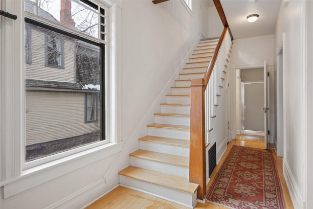 stairs featuring wood-type flooring