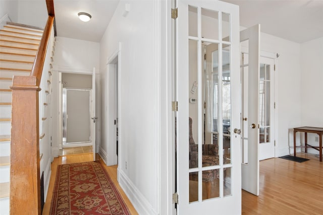 corridor with hardwood / wood-style floors