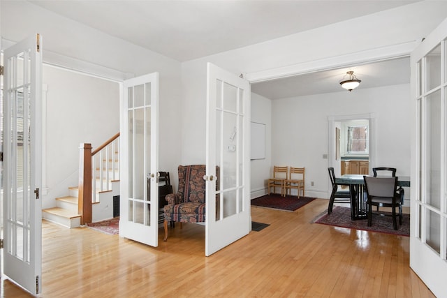 dining room with french doors and hardwood / wood-style flooring