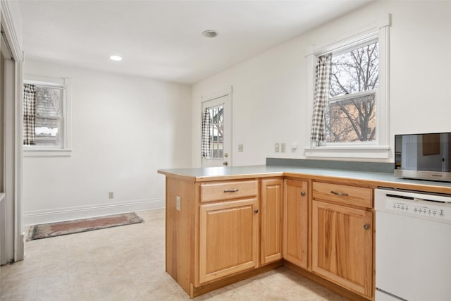 kitchen with white dishwasher and kitchen peninsula