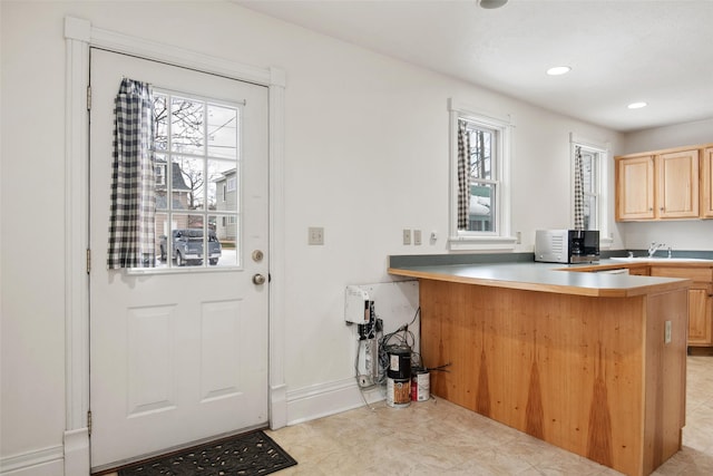 interior space featuring kitchen peninsula and light brown cabinetry