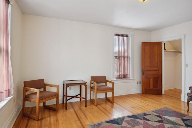 sitting room featuring hardwood / wood-style flooring and plenty of natural light