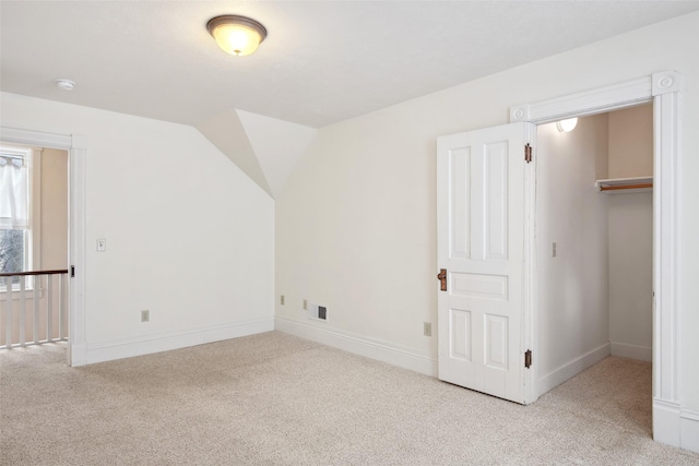 additional living space featuring light carpet