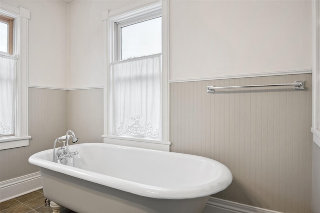 bathroom featuring tile patterned floors and a washtub