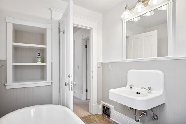 bathroom with tile patterned flooring and a bathing tub