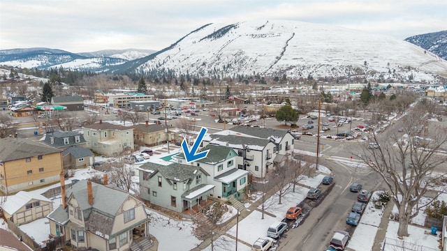 snowy aerial view featuring a mountain view