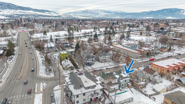 snowy aerial view featuring a mountain view