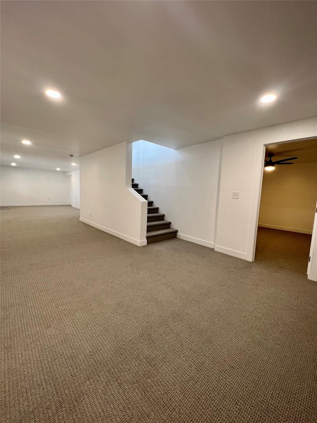 basement featuring dark colored carpet