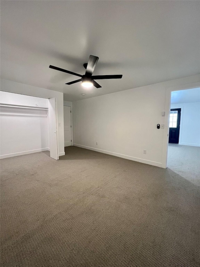 interior space featuring ceiling fan and carpet flooring