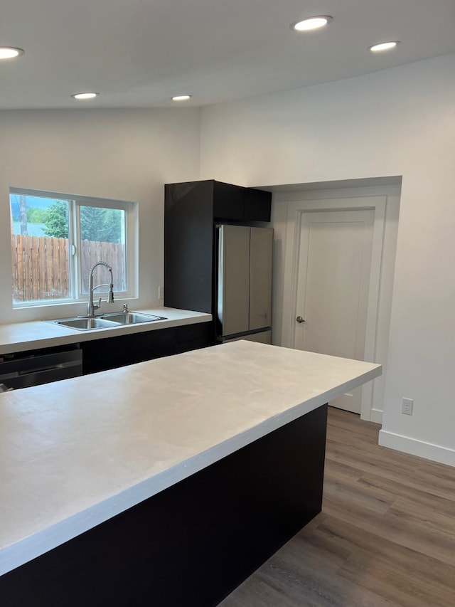 kitchen featuring sink, dishwasher, dark hardwood / wood-style floors, and stainless steel refrigerator