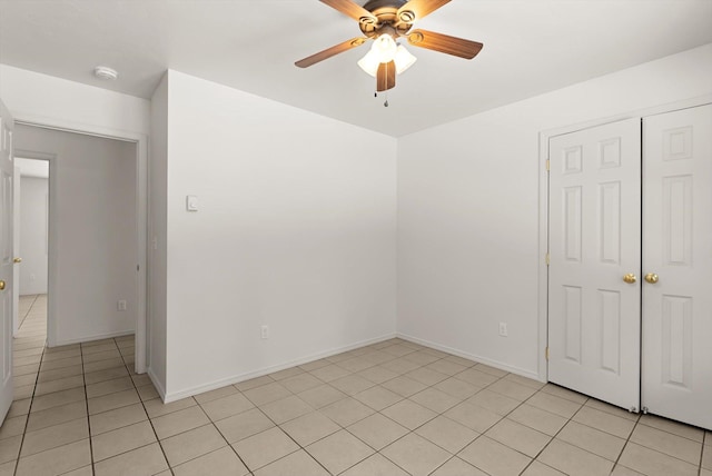 tiled empty room featuring ceiling fan