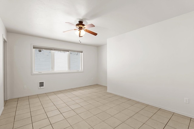 tiled spare room featuring ceiling fan