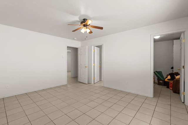 unfurnished room featuring light tile patterned flooring and ceiling fan