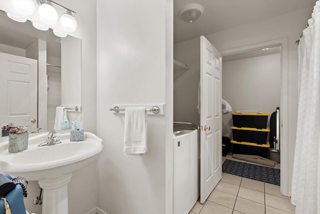 bathroom featuring washer / dryer and tile patterned floors