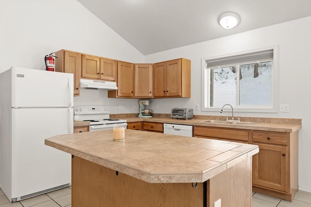 kitchen featuring white appliances, a center island, light tile patterned floors, lofted ceiling, and sink